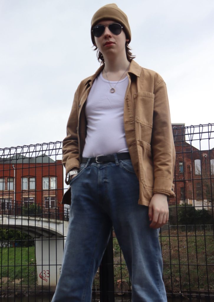 Joe standing in front of a fence.