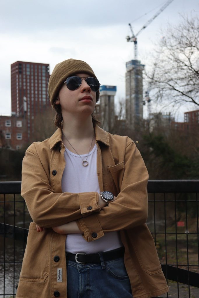 Joe crossing his arms in front of a skyline.