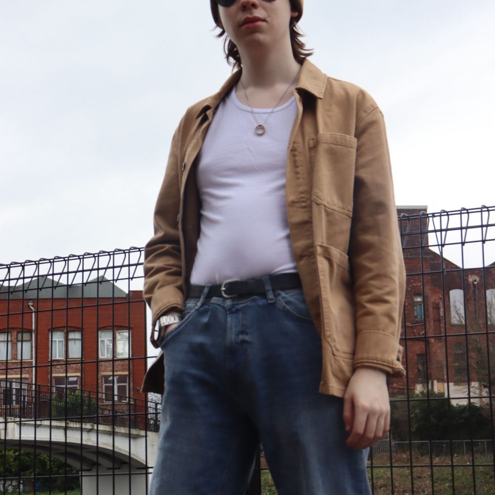 Joe standing in front of a fence.